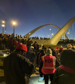 Interfaith gathering at the Frederick Douglass Bridge in Washington DC, January 11, to demonstrate against the killing of Renee Good.)