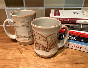 book mugs next to my favorite philosophy and feel good books
