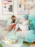 Two friends chatting on a cream sofa