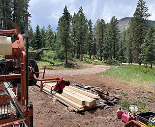 Portable sawmill milling logs in Southwest Colorado