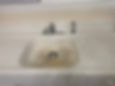 Stained white kitchen sink with chrome faucet and sprayer