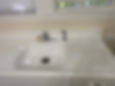White cast iron drainboard sink with chrome faucet