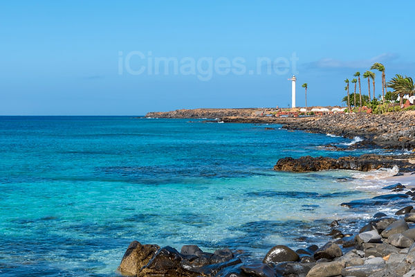 The view of Punta Pechiguera lighthouse along the beautiful coastline of Playa Blanca.