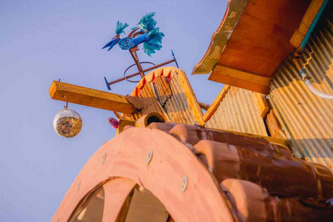 a disco ball hangs from the roof of a building