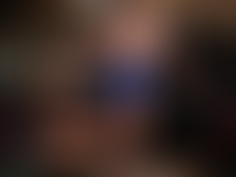 Two muscular people exercising in a gym; the man lifts a barbell, the woman lunges with dumbbells. Mirrors and weights surround them. Determined mood.