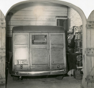 Bookmobile parked in garage at Main Library. (1953). [Photograph]. The Charleston Archive at CCPL