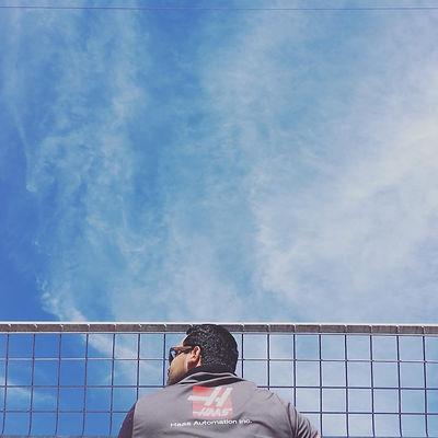 Michael wearing sunglasses looking at the sky