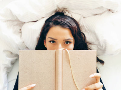 A girl reading on a bed