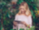 blonde-young-woman-standing-near-green-plants-looking-digital-tablet.jpg