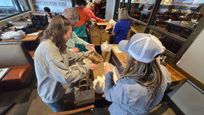 Volunteers assembling care packages for our Protect the Bond event