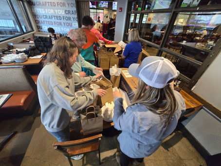 Volunteers assembling care packages for our Protect the Bond event