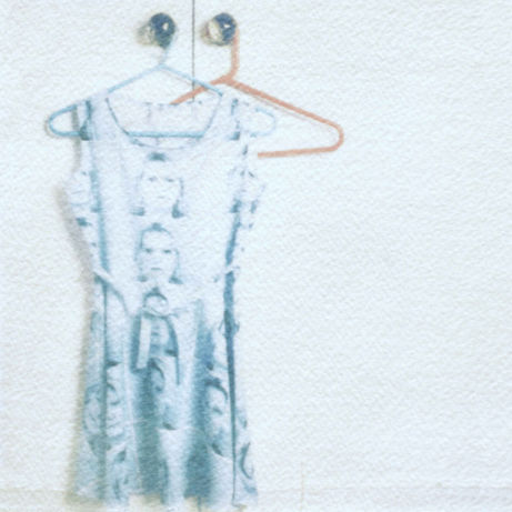 Polaroid emulsion lift of a cyanotype dress with a print of twin sisters.
