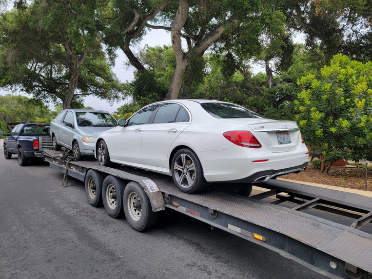 white sedan on car hauler