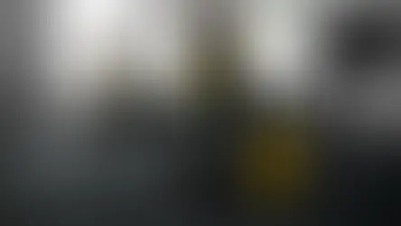 Workers cleaning an office with vacuum and table wipes.