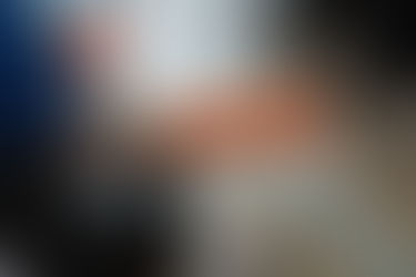 Person wearing orange gloves cleaning a glass table