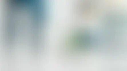 Workers cleaning a bright modern room with mop and cloth.