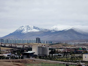 Snow-Capped Peaks Above the City