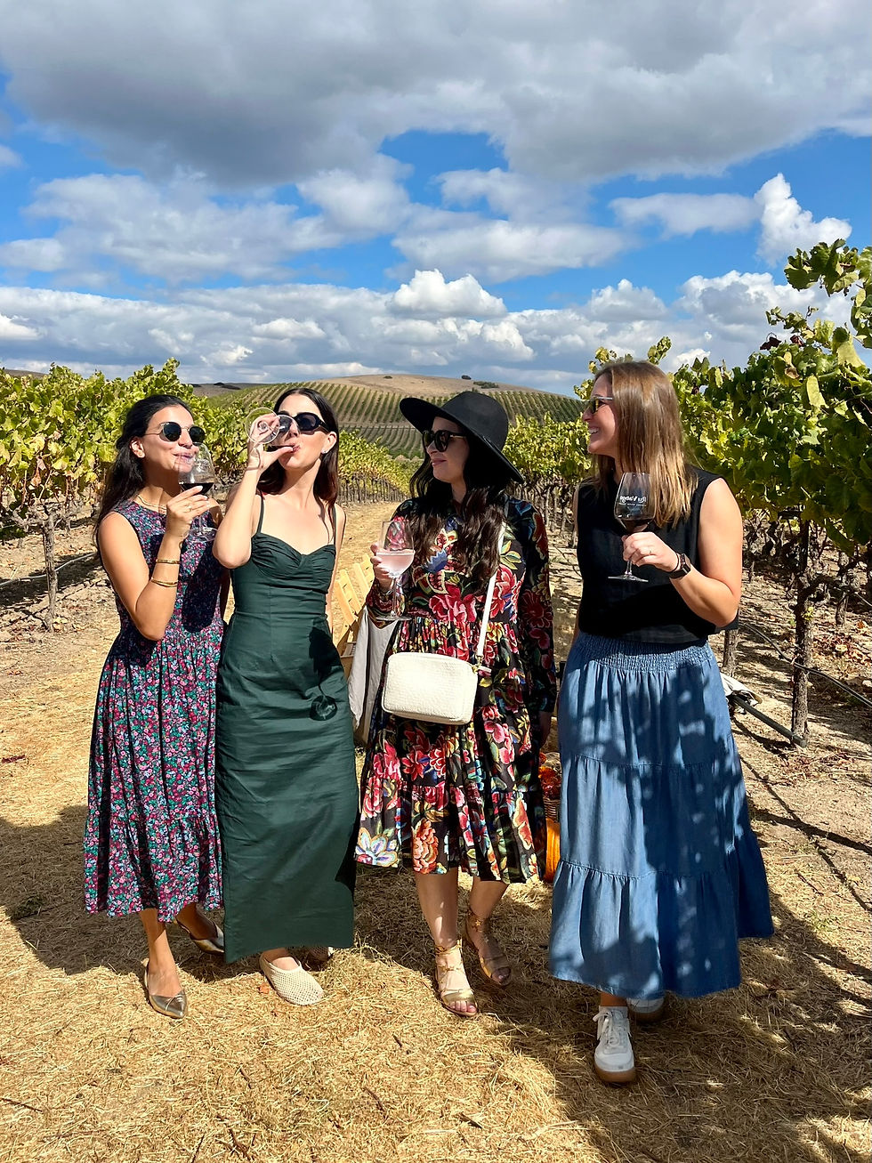 Girls in a napa vineyard drinking wine