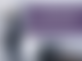 Woman standing at kitchen counter sorting through papers, looking down, with signs of others' lives on the table behind her — overfunctioning in relationships, doing too much for others