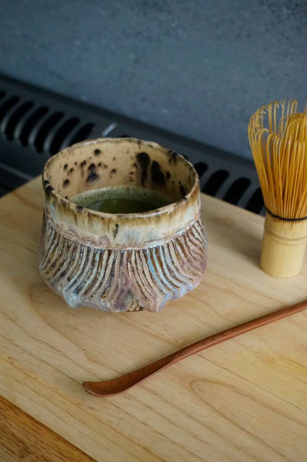 Thumbnail: Ceramic Japanese-inspired tea bowl with cream, pink and blue glaze top view