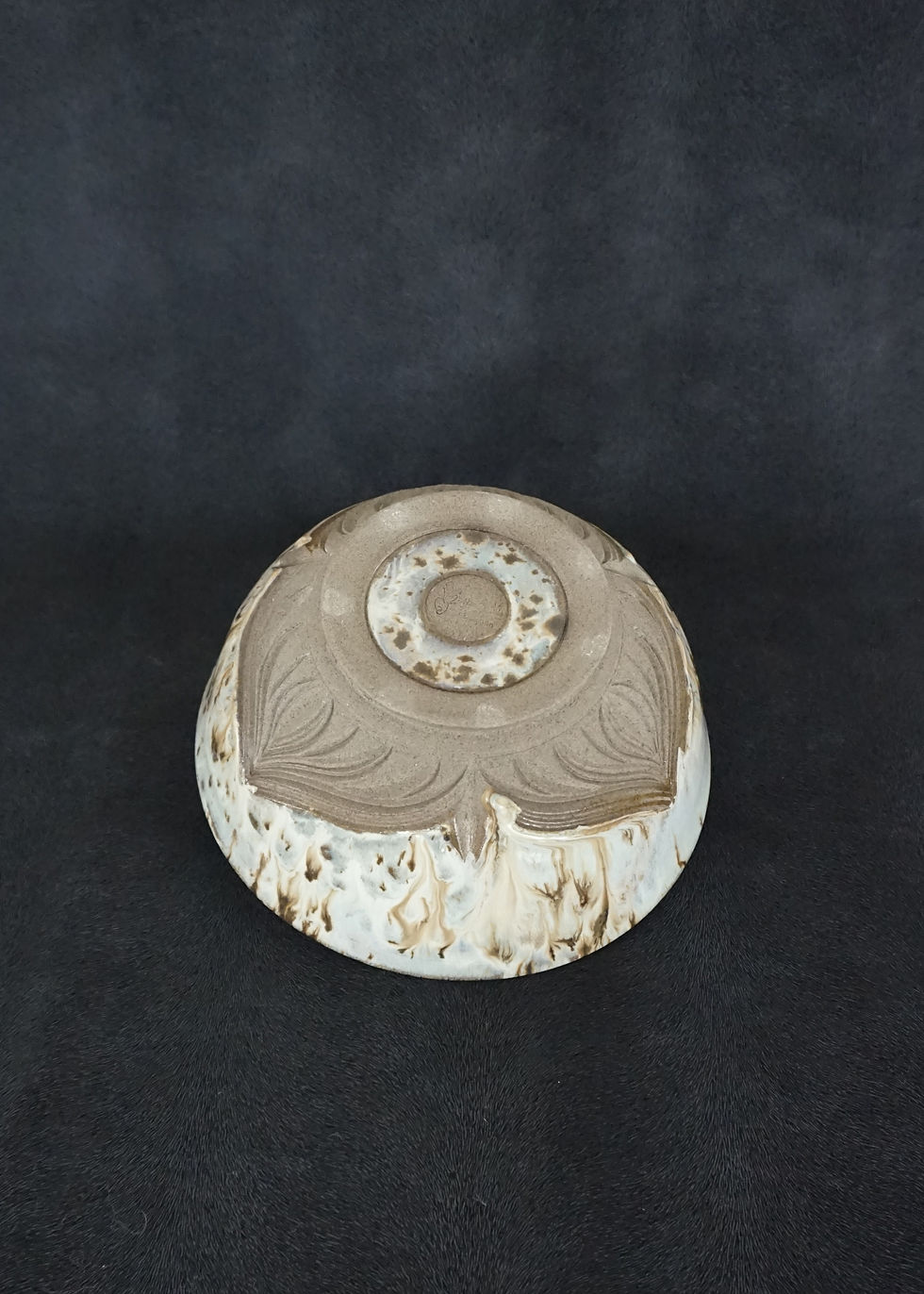 Thumbnail: Ramen bowl in a grey clay with a white, lavender and blue glaze bottom view