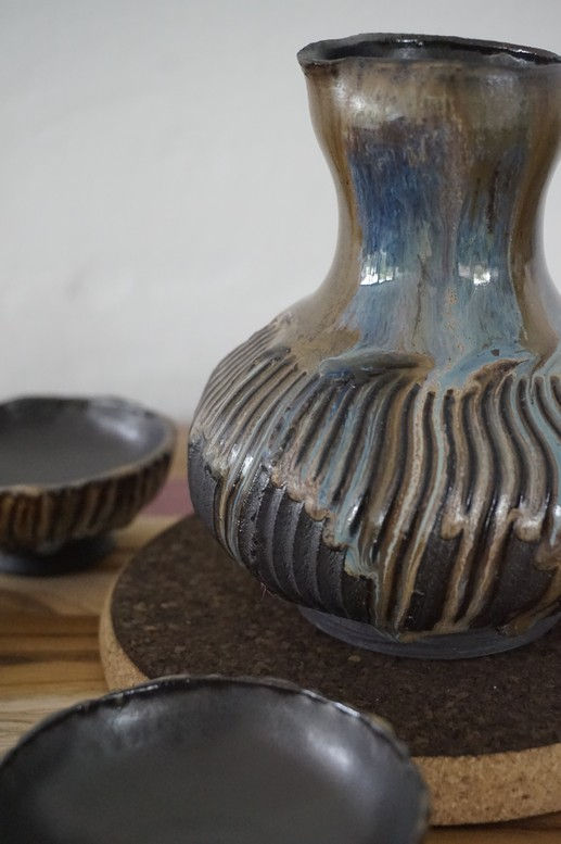 Thumbnail: Black, blue and gold ceramic sake set with 4 cups and a bowl side view