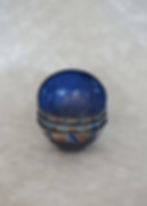 4 ceramic bowls with a brown, pink and blue glaze with indigo interior stacked on top of each other side view