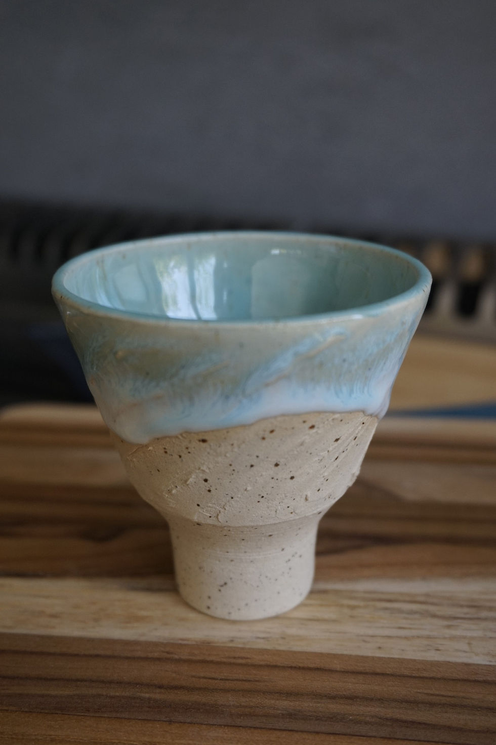 Thumbnail: Cream, white, and blue ceramic Japanese-inspired sake cup side view