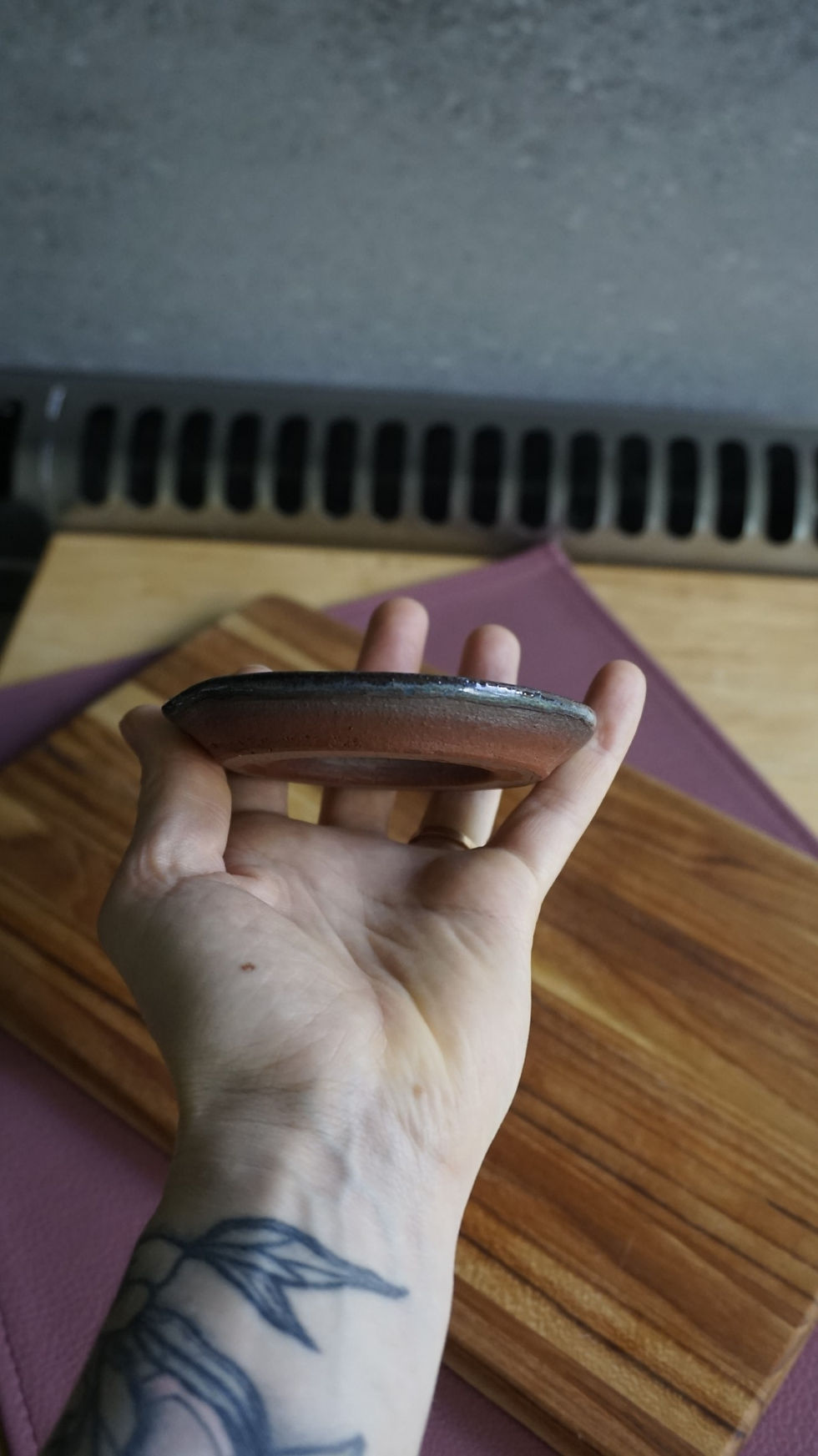 Thumbnail: Green pottery ginger grater in a hand side view