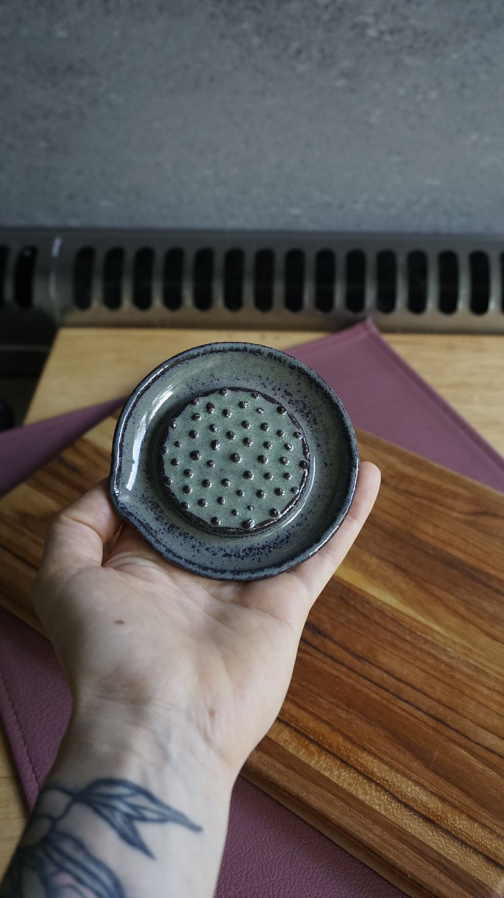 Thumbnail: Green pottery ginger grater in a hand top view