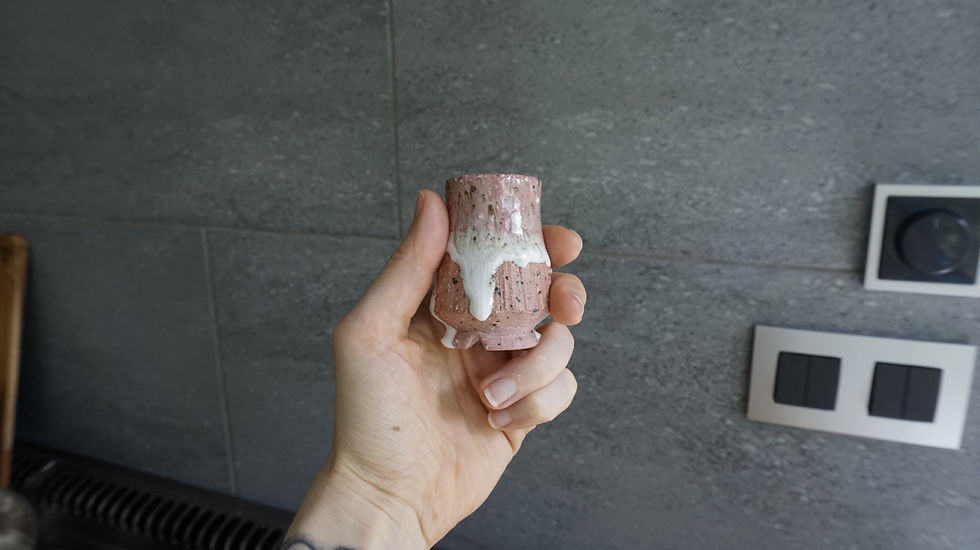 Thumbnail: Pink ceramic Japanese sake cup with white drippy glaze side view