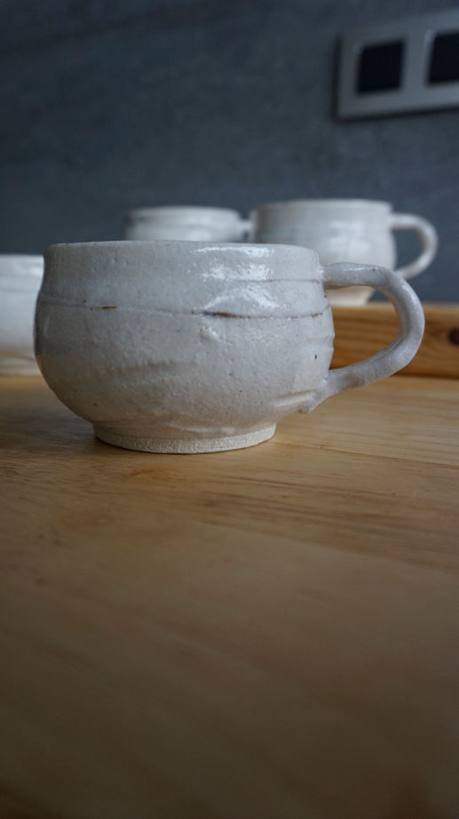 Thumbnail: four wabi sabi mugs with a shino glaze side view