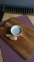 White and blue stoneware ginger grater with a pieces of ginger top view
