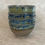 Thumbnail: 4 ceramic cereal bowls with a green and blue glaze stacked on top of each other