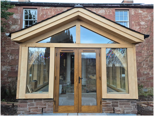 Bespoke oak-framed glass extension with pitched roof on stone house in Angus, Scotland.