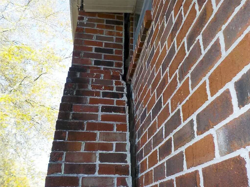 Tilted brick chimney showing severe foundation damage in Arlington Texas home.