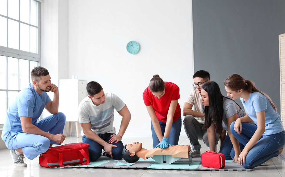 Instructor demonstrating CPR on mannequin at first aid training course.jpg