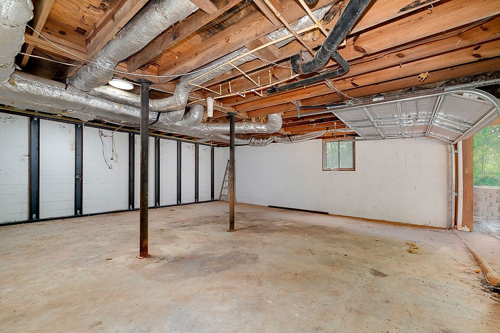 Basement space in Johns Creek, GA, poised for transformation by Perspective Designs and Renovation, showcasing an expansive floor area, visible ductwork, and a partially exposed ceiling.