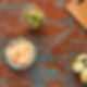 A vibrant table features a bowl of tortilla chips and guacamole with lime