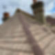 Rooftop view of a house with weathered, brown shingles