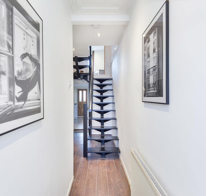 A bright hallway with elegant black-and-white artwork
