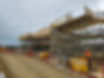Workers in hard hats are constructing a building