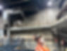 Long horizontal metal ventilation duct pipe fixed to an external concrete wall with structural framework