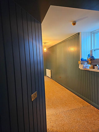 Narrow hallway with dark paneling