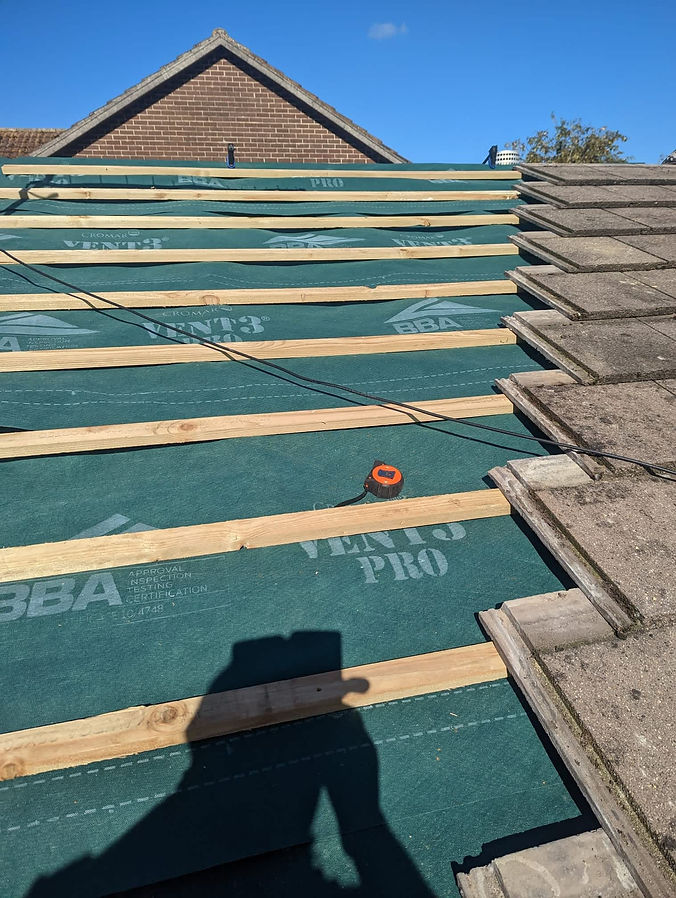 Wooden beams on green tarpaulin