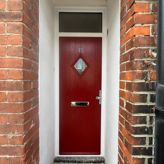 Red door with number 15, featuring a diamond-shaped window