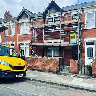 Scaffolding covering the front of a suburban house