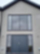 Modern house facade with a large gray double door and matching windows