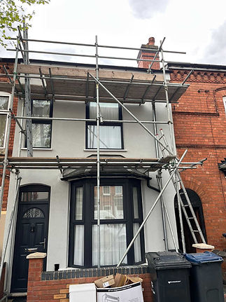House with white render and black window frames