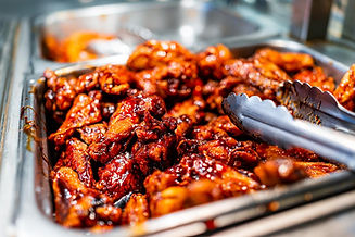 Glazed barbecue chicken wings in a serving tray